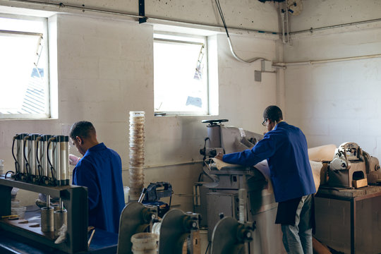 Two men working in a sports equipment factory