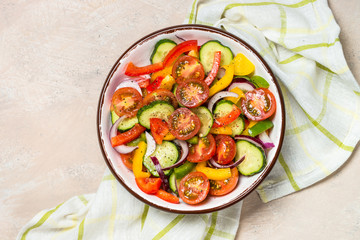Vegetable salad on light table top view.