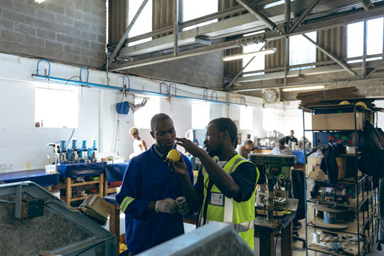 Two men working together in a sports equipment factory