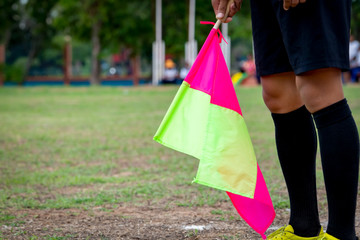 Flag soccer in hand of assistant referee soccer football 