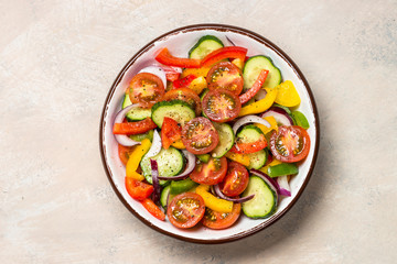 Vegetable salad on light table top view.