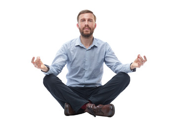 young businessman meditates sitting on the floor