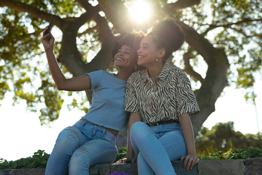 Two young women taking selfie outdoors