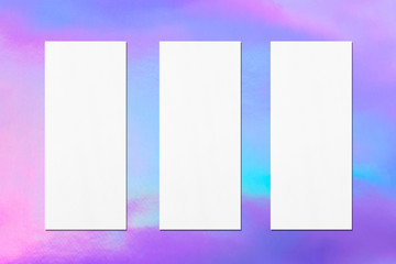Three empty price-list or menu mockups with soft shadows on holographic background. Flat lay, top view