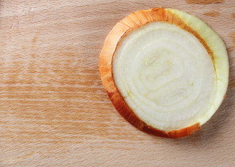Fresh cut onion slice on wooden chopping board isolated on white background