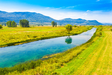 Naklejka na ściany i meble Beautiful landscape in valley of Gacka river, field aerial summer view, Lika region of Croatia