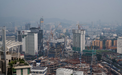Obraz premium Aerial drone view of Kuala Lumpur city skyline during cloudy day, Malaysia