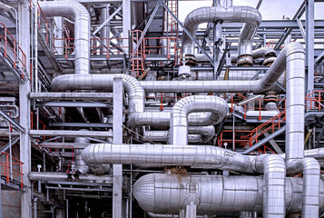 Oil and gas refinery plant form industry petroleum zone,Refinery equipment pipeline steel and oil storage tank at sunrise. -image