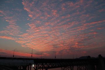 vibrant clouds during golden hour by a bridge near the Golden Gate in San Francisco CA