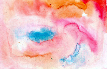 Beautiful abstract smudges of orange, red, blue and pink colors in hand painted watercolor background design