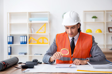 Young male architect working in the office