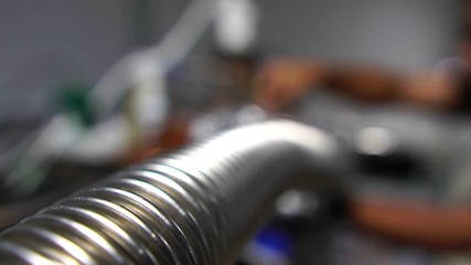 A close-up, the hand of technician composite pipe vacuum system of radiation radioactive footage slow motion