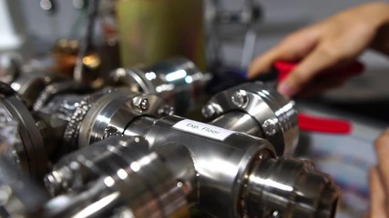 A close-up, the hand of technician composite pipe vacuum system of radiation radioactive footage slow motion