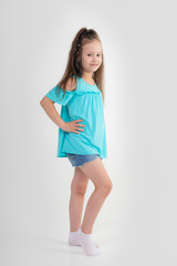 Thoughtful little girl six years old daughter look away on copy space thinking isolated on grey beige background, funny kid pout lips hold finger near mouth conceived some kind of prank, concept image