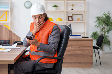 Young male architect working in the office