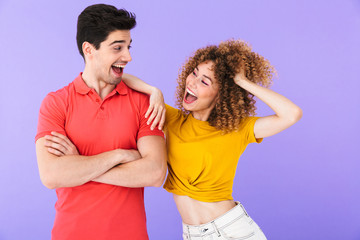 Portrait of delighted caucasian people man and woman in basic clothing smiling together and looking at each other