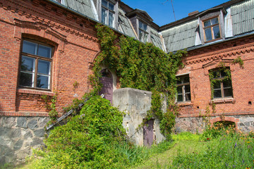 Fototapeta na wymiar Old and abandoned mansion in Latvia, sunny day time