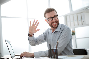 friendly businessman sitting at the office Desk