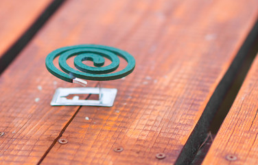 anti mosquito spiral repellent smoke on wooden table