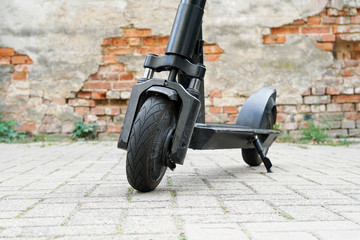 Electric kick scooter or e-scooter parked on pavement - e-mobility or micro-mobility trend © Axel Bueckert