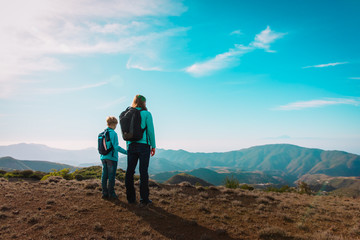 family travel, mother and son looking at scenic view while hiking