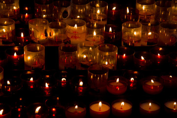 Burning prayer candles in a church
