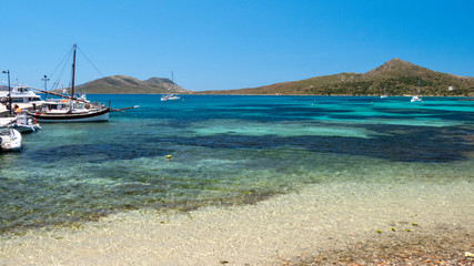 Clear amazing azure coloured sea water with granite rocks in Capriccioli beach, Sardinia, Italy.