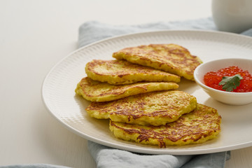 Zucchini pancakes with potato and red caviar, fodmap keto diet side view closeup