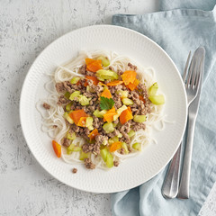 Delicious rice pasta with mince meat and vegetables, top view