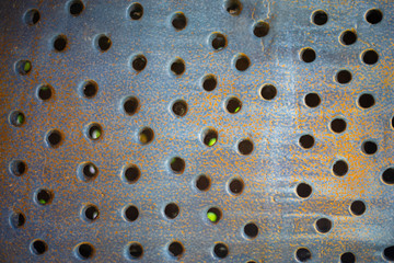 The surface of the wallpaper is round holes, copper rust color.
