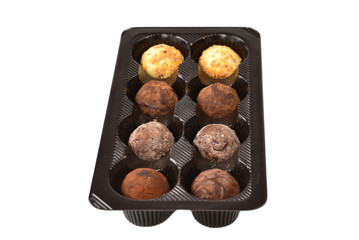 Chocolate candy collection in plastic box.