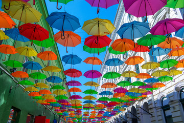 Fototapeta na wymiar Colorful umbrellas hanging over the old streets of Timisoara city center, Romania. Photo taken on 20st of September 2018.