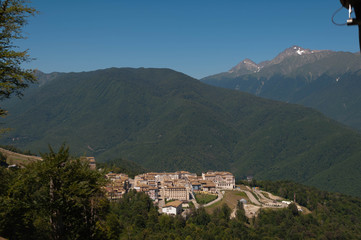 a group of hotels surrounded by forests and mountains