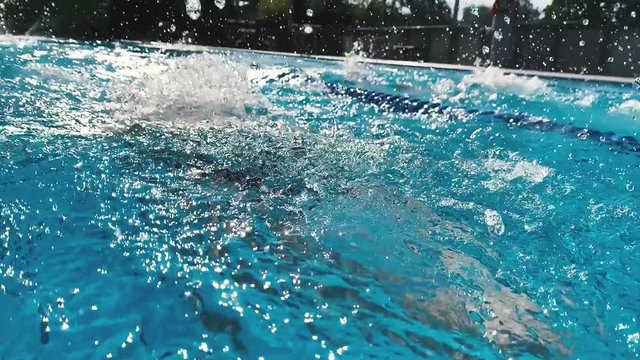 Professional swimmer in slow motion. Woman swim breaststroke in pool