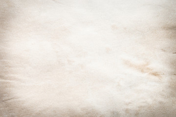 Old brown and white paper stained with coffee. Vintage abstract background.