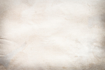 Old brown and white paper stained with coffee. Vintage abstract background.