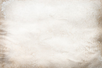 Old brown and white paper stained with coffee. Vintage abstract background.