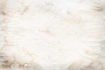 Old brown and white paper stained with coffee. Vintage abstract background.