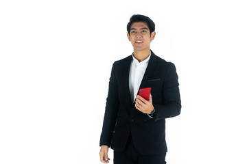 Handsome young businessman Asian caucasian wear a black suit with black hair, be a smile and standing smart poses. Hold and use a smartphone. On white background.