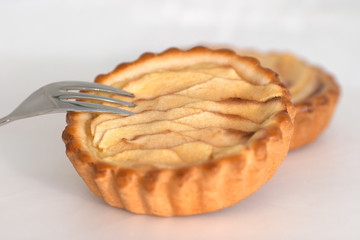 Piece of home made apple cake on white background