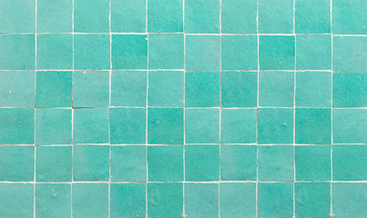 Old retro azure green ceramic tile texture background. Azure green square tiled wall.