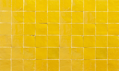 Old retro yellow ceramic tile texture background. Yellow square tiled wall.