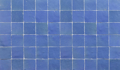 Old retro blue ceramic tile texture background. Blue square tiled wall.