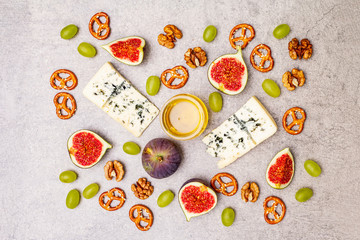 Cheese appetizer selection or wine snack set. Blue cheese, figs, honey, walnuts, pretzels