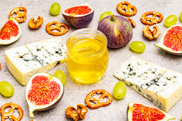 Cheese appetizer selection or wine snack set. Blue cheese, figs, honey, walnuts, pretzels