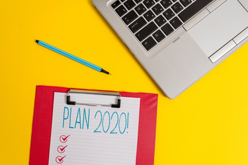 Writing note showing Plan 2020. Business concept for detailed proposal doing achieving something next year Trendy metallic laptop clipboard paper sheet marker colored background