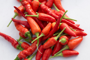 chili peppers selection on white table background.