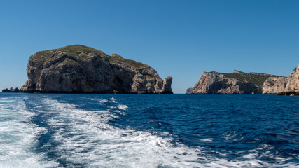 Fototapeta na wymiar high cliffs in the sea. blue wild water