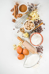 Ingredients for autumn winter festive baking - flour, brown sugar, eggs, chocolate drops, butter, cinnamon on stone or concrete background.Top view copy space.