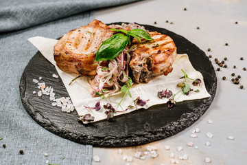 Tasty roasted steak with spices on the wooden background